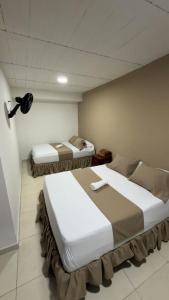 a room with two beds in a room at HOTEL DULCES SUEÑOS N°2 in Tuluá +4 photos