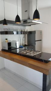 a kitchen with a stove and a counter top at Orion 2nd Floor in Tepic