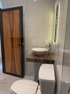 a bathroom with a toilet and a sink at Orion 2nd Floor in Tepic +27 photos