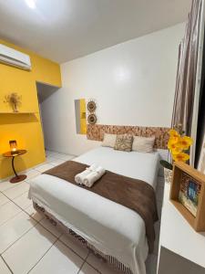 a bedroom with a large bed in a room at Bru&Mar Pousada in Parnaíba