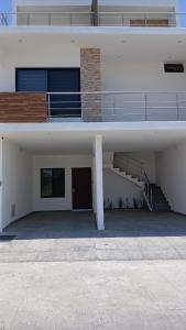 a large white building with a staircase and a ramp at Loft with Private Terrace in Tepic