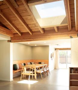 a dining room with a table and a couch at Sonoran Peach - Light-Filled 5BR near TMC in Tucson +32 photos
