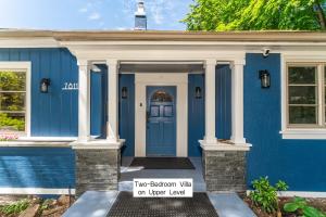 a blue house with a blue door and a sign at 7811 The Solace Vista in Vancouver