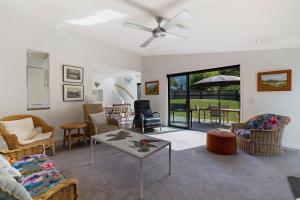 a living room with a couch and chairs and a table at Chartres Retreat in Arrowtown