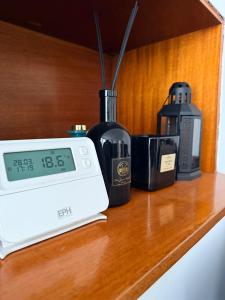 a clock sitting on top of a counter next to appliances at The Alcove Retreat in Bristol