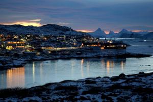 a view of a city at night with a river at Hotel Arctic in Ilulissat