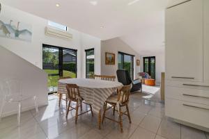 a kitchen and dining room with a table and chairs at Chartres Retreat in Arrowtown