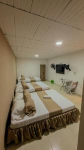 a room with a bunch of beds in it at HOTEL DULCES SUEÑOS N°2 in Tuluá