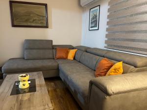 a living room with a couch and a table at Vikendica Silenzio in Cetinje