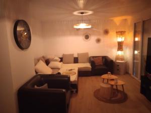 a living room with a couch and a table at Chambre privée villa montelimar in Montélimar