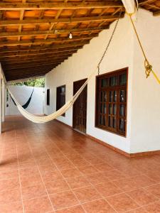 a porch with a hammock hanging from a house at Casa Ale in Brisas de Zicatela