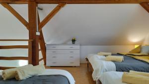a bedroom with two twin beds and a dresser at Peaceful Family Apartments near Terme Čatež in Čatež ob Savi