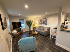 a living room with a couch and a tv at The Dollar House in Albert Lea