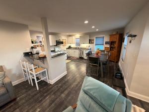 a living room and kitchen with a couch and a table at The Dollar House in Albert Lea