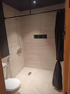 a bathroom with a shower with a toilet at Trésors des Ancêtres in Ibrahene +37 photos