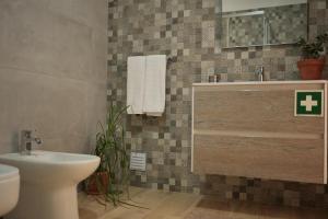 a bathroom with a sink and a toilet at Casas Luar da Aldeia - Apartamentos in Odeceixe +19 photos