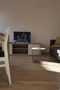 a living room with a tv and a couch at Casas Luar da Aldeia - Apartamentos in Odeceixe