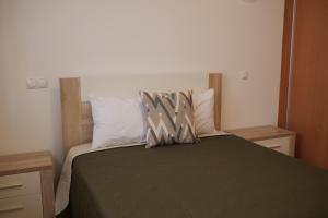 a bedroom with a bed with two pillows on it at Casas Luar da Aldeia - Apartamentos in Odeceixe