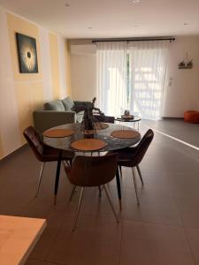 a living room with a table and chairs and a couch at Chez Mathieu in Saint-Dizier