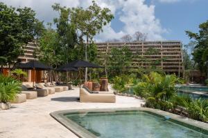 a resort with a swimming pool and a building at Casa Kaybe in Tulum