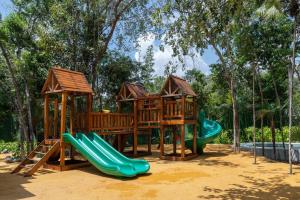 a playground with two slides and a play structure at Casa Kaybe in Tulum