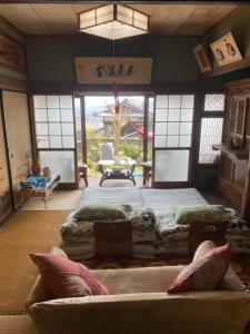 a living room with two beds and a couch at Inn Omishima in Imabari