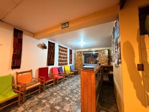 a room with chairs and a table and a counter at Hospedaje Inti in Pisac
