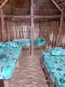 a room with three beds in a straw hut at CABAÑA ARRIYALADUP San-Blas in Arritupo Número Dos +7 photos