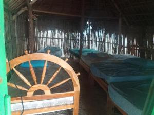 a room with three beds in a straw hut at CABAÑA ARRIYALADUP San-Blas in Arritupo Número Dos