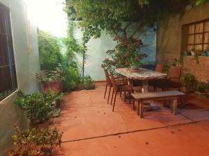 a patio with a table and chairs and plants at Casa Centrica 2 habitaciones con Cochera SL Cap in San Luis