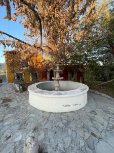 a fountain in the middle of a stone courtyard at Yellow House, Private Apartment, Centro Arteaga in Arteaga