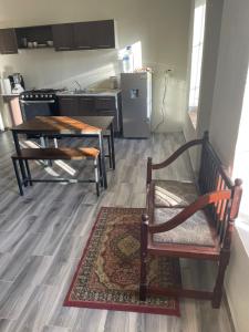 a kitchen with a table and a chair and a table at Yellow House, Private Apartment, Centro Arteaga in Arteaga