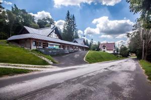 a house on the side of a road at Studio with Pool in Benecko-Riesengebirge 2218 in Benecko