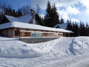a snow covered slope in front of a building at Studio with Pool in Benecko-Riesengebirge 2218 in Benecko