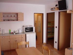 a kitchen with a white refrigerator and a microwave at Studio with Pool in Benecko-Riesengebirge 2218 in Benecko +10 photos
