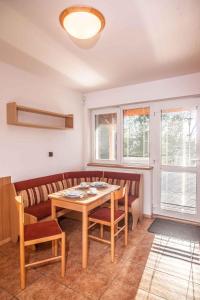 a dining room with a wooden table and chairs at Studio with Pool in Benecko-Riesengebirge 2218 in Benecko