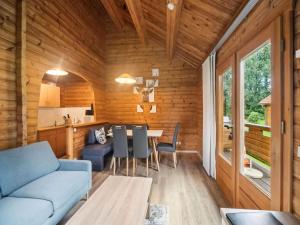 a living room with a couch and a table at Finnische Blockhausstilhäuser im Harz in Benneckenstein