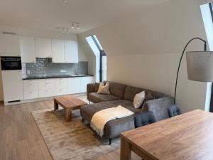 a living room with a couch and a table at City apartment with terrace in Hasselt