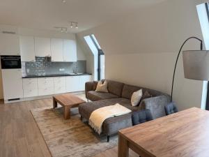a living room with a couch and a table at City apartment with terrace in Hasselt