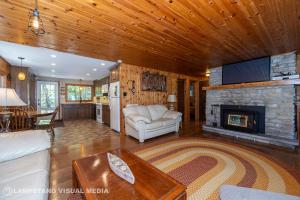 a living room with a couch and a fireplace at Breezy Woods - Tobermory Waterfront in Tobermory
