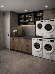 a kitchen with two washing machines and a sink at Voltage Lodge Collie in Collie