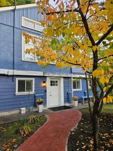 a blue building with a white door and a red brick driveway at 7811 The Solace Vista in Vancouver