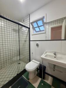 a bathroom with a toilet and a sink at BeInn - Short Stay Collection Penedo in Itatiaia +24 photos
