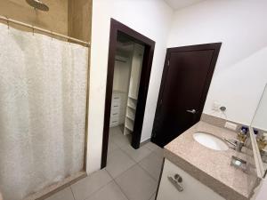 a bathroom with a shower and a sink and a mirror at Habitación en el Tornero in SamborondÃ³n