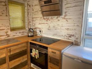a small kitchen with a stove and a sink at Central location Sea view in Hastings
