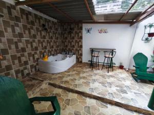 a bathroom with a tub and a table and chairs at Casa Aranza in Cartagena de Indias +24 photos