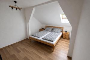 a bedroom with a bed and a wooden floor at HannaBella Vendégház & Wellness in Miskolc +10 photos