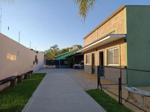 a sidewalk in front of a building at Palmeras al sol in San Pedro