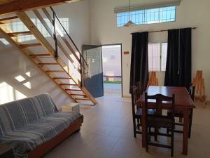 a living room with a couch and a dining room table at Palmeras al sol in San Pedro