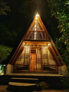 a small house with lights on the front of it at Velya cabana in Belihuloya +3 photos